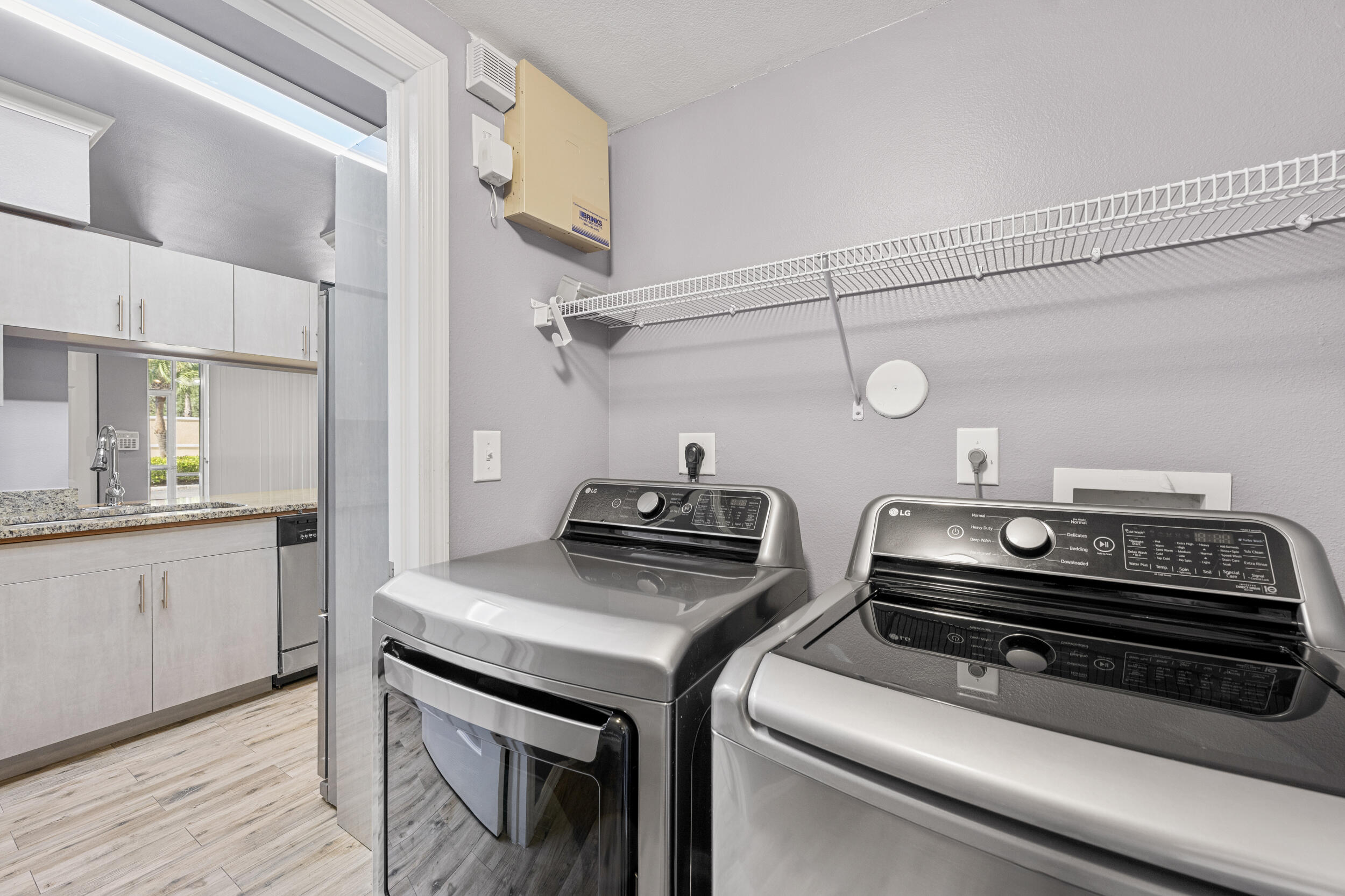 6410 Emerald Dunes Drive, Unit 101 West Palm Beach, FL 33411 - Photo 10 of 39 a kitchen that has a stove and a microwave oven