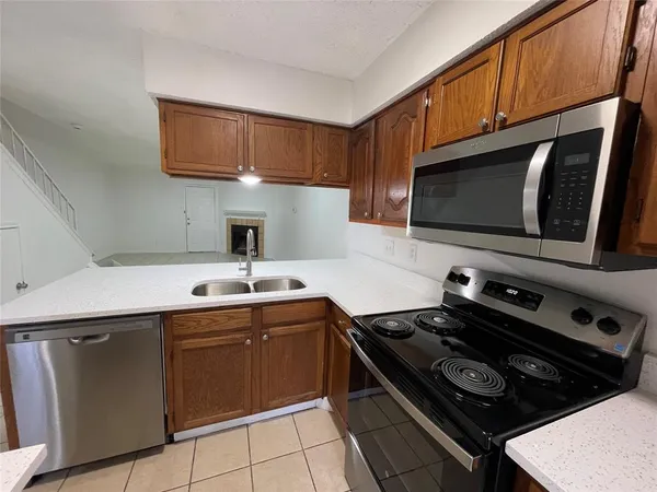 a kitchen with a stove a sink and a microwave