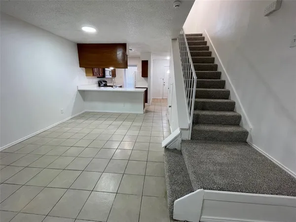 a view of kitchen and hall with wooden floor