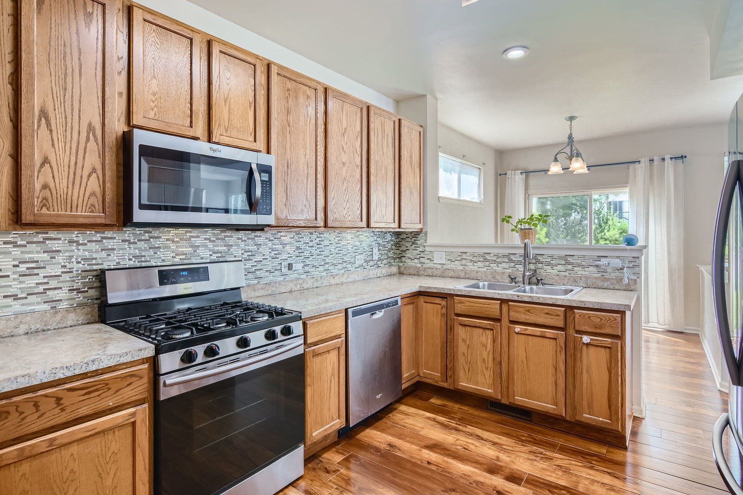 487 West Hamlin Lane Round Lake, IL 60073 - Photo 16 of 28 a kitchen with granite countertop cabinets stainless steel appliances and a window