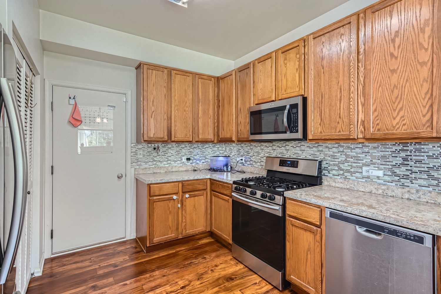 487 West Hamlin Lane Round Lake, IL 60073 - Photo 17 of 28 a kitchen with granite countertop stainless steel appliances wooden cabinets and a stove top oven