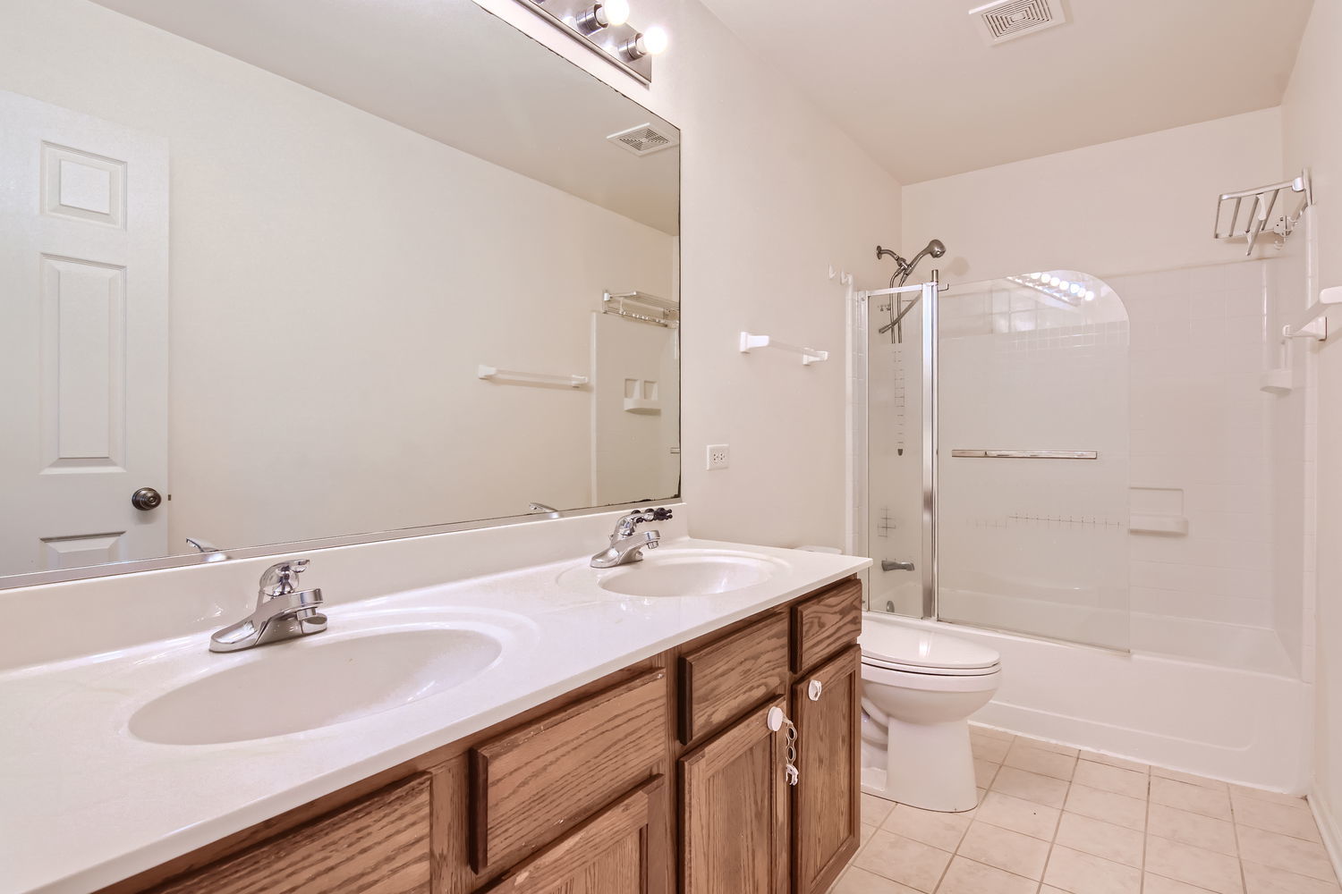 487 West Hamlin Lane Round Lake, IL 60073 - Photo 23 of 28 a bathroom with a sink toilet double vanity and shower