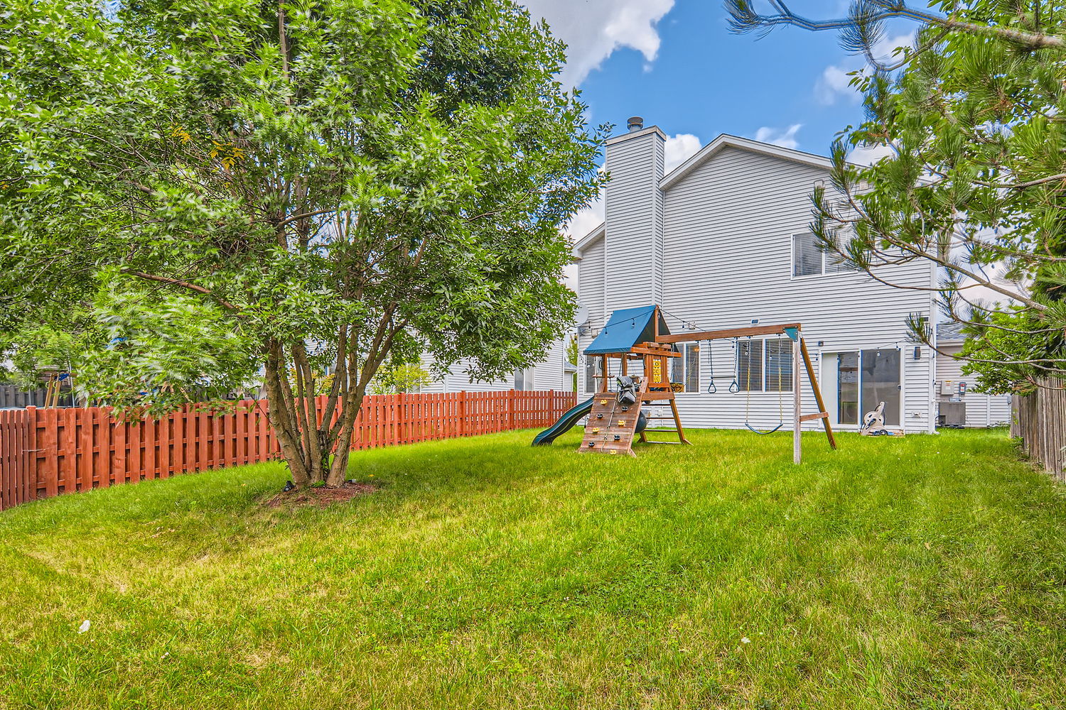 487 West Hamlin Lane Round Lake, IL 60073 - Photo 4 of 28 a view of backyard with a garden and deck