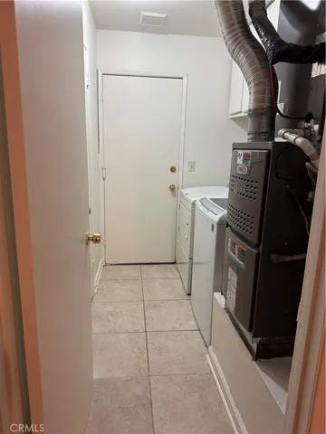 a view of storage and utility room with washer and dryer