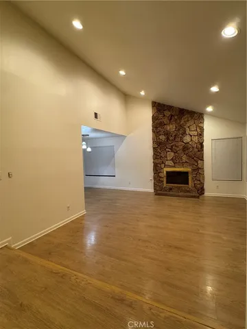 a view of empty room with a fireplace