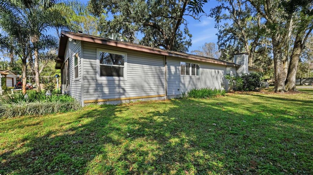 10565 Bessemer Street New Port Richey, FL 34654 - Photo 41 of 72 a view of backyard of house with green space
