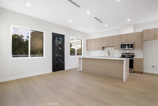 a view of kitchen with cabinets and refrigerator