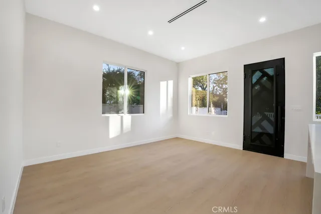 an empty room with windows and closet