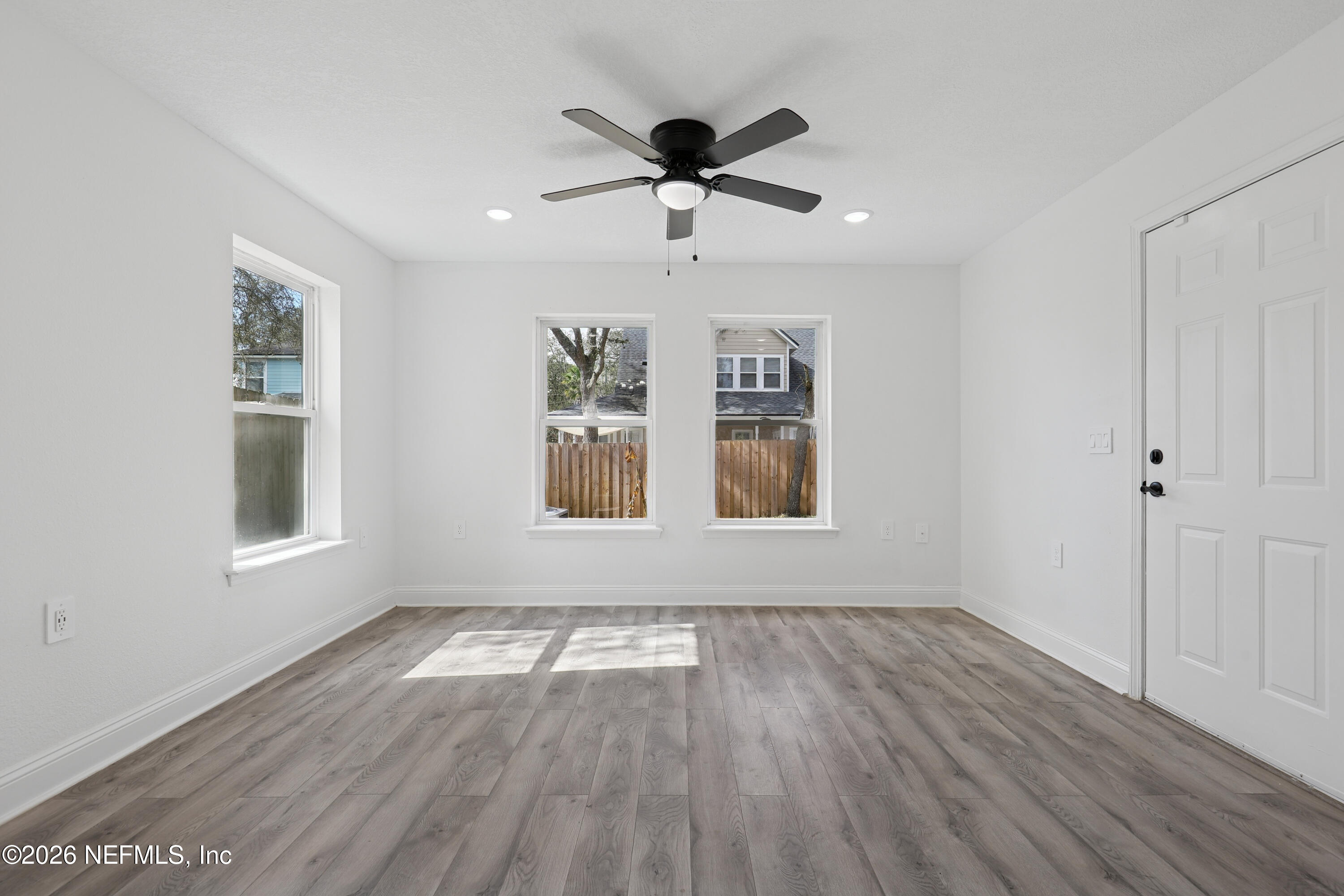 1022 Penman Road Jacksonville Beach, FL 32250 - Photo 26 of 52 a view of empty room with wooden floor and fan