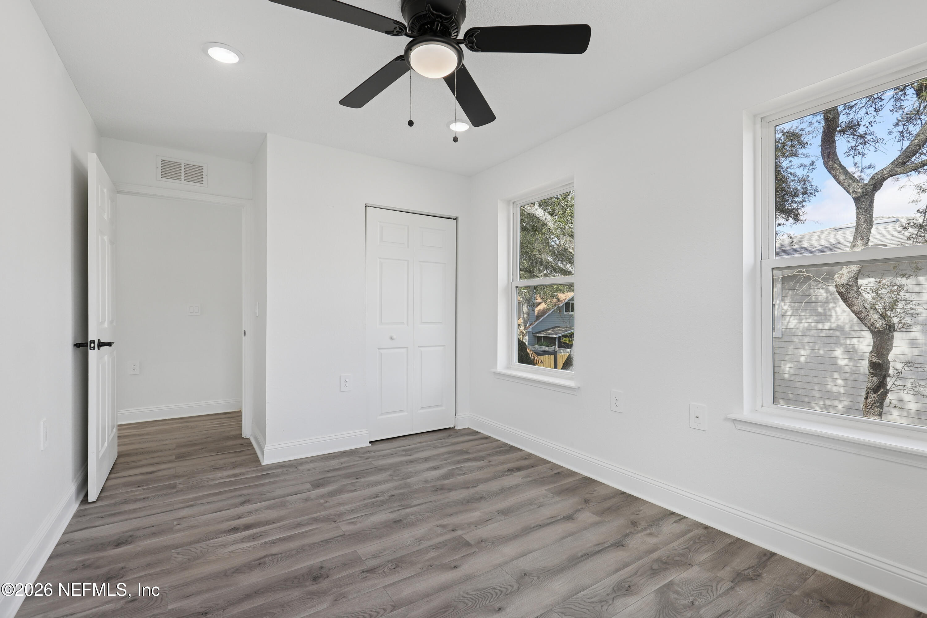 1022 Penman Road Jacksonville Beach, FL 32250 - Photo 36 of 52 wooden floor in an empty room with a window
