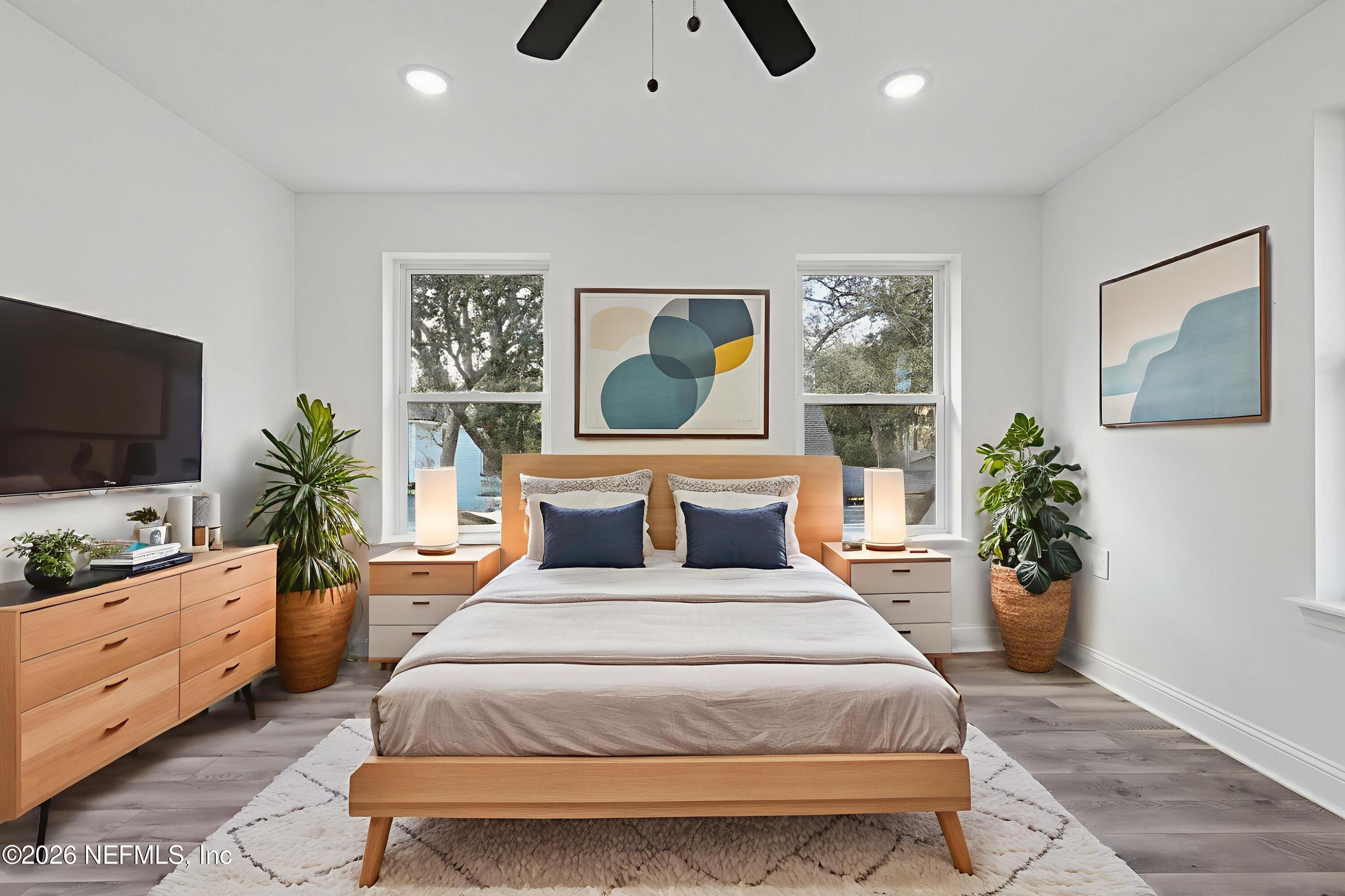1022 Penman Road Jacksonville Beach, FL 32250 - Photo 9 of 52 a bedroom with a large bed and a flat tv screen on dresser