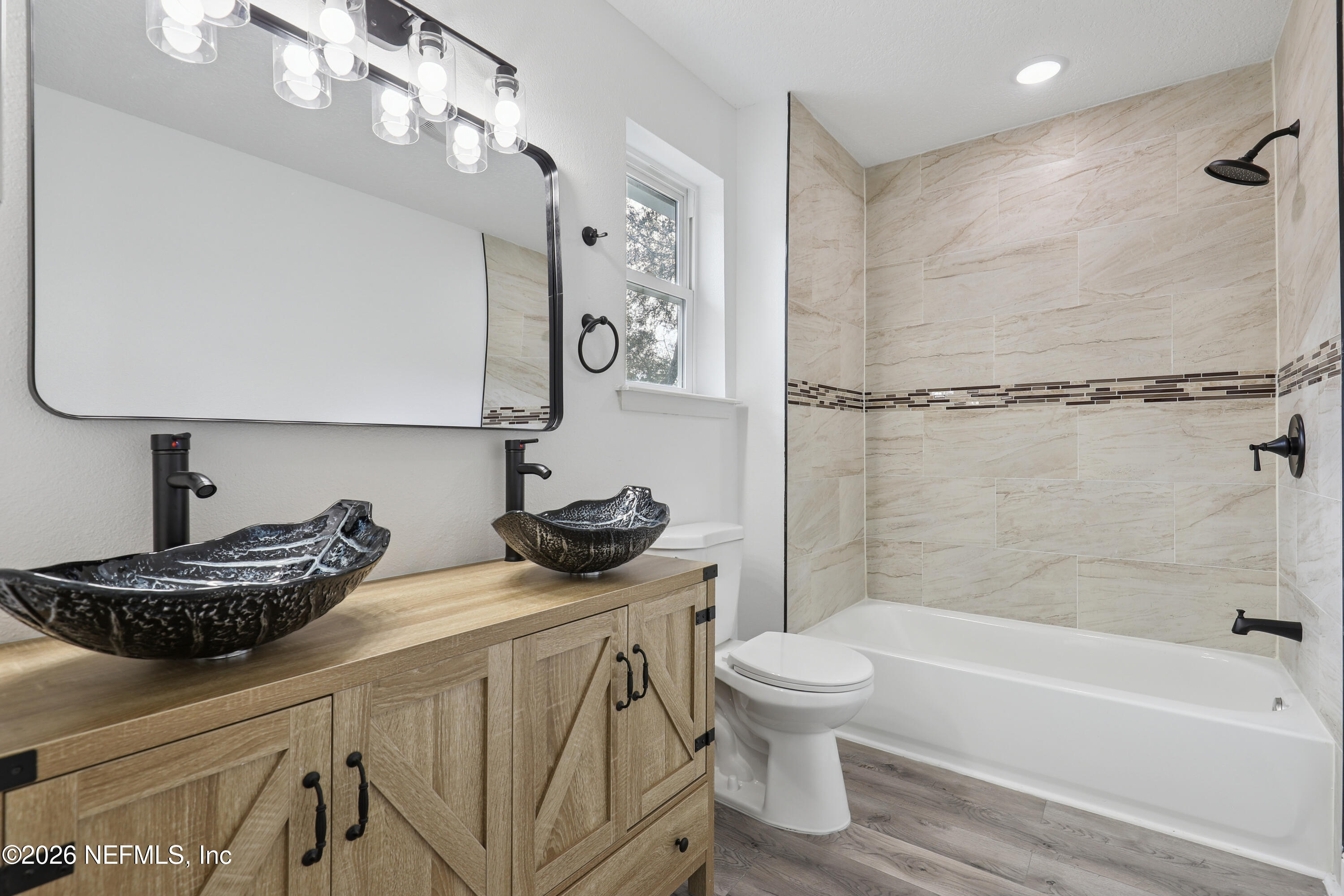 1022 Penman Road Jacksonville Beach, FL 32250 - Photo 10 of 52 a bathroom with a tub sink toilet and a mirror
