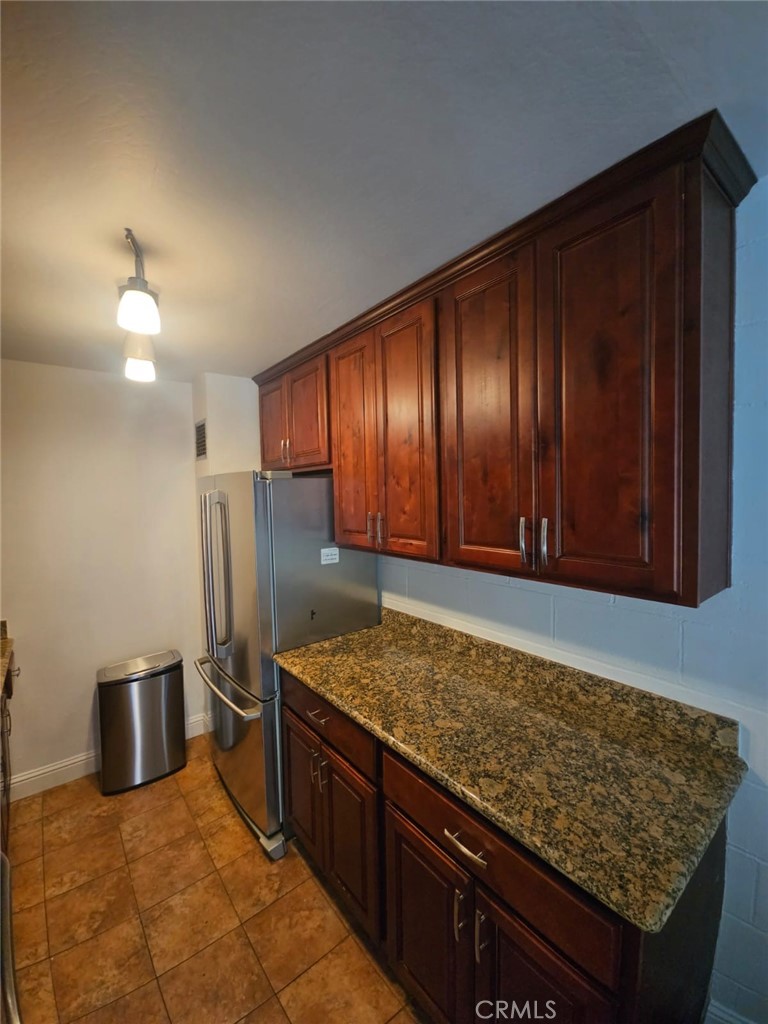 75 Western Shore Lane, Unit 1 San Francisco, CA 94115 - Photo 11 of 17 a kitchen with stainless steel appliances granite countertop wooden cabinets a refrigerator and a sink