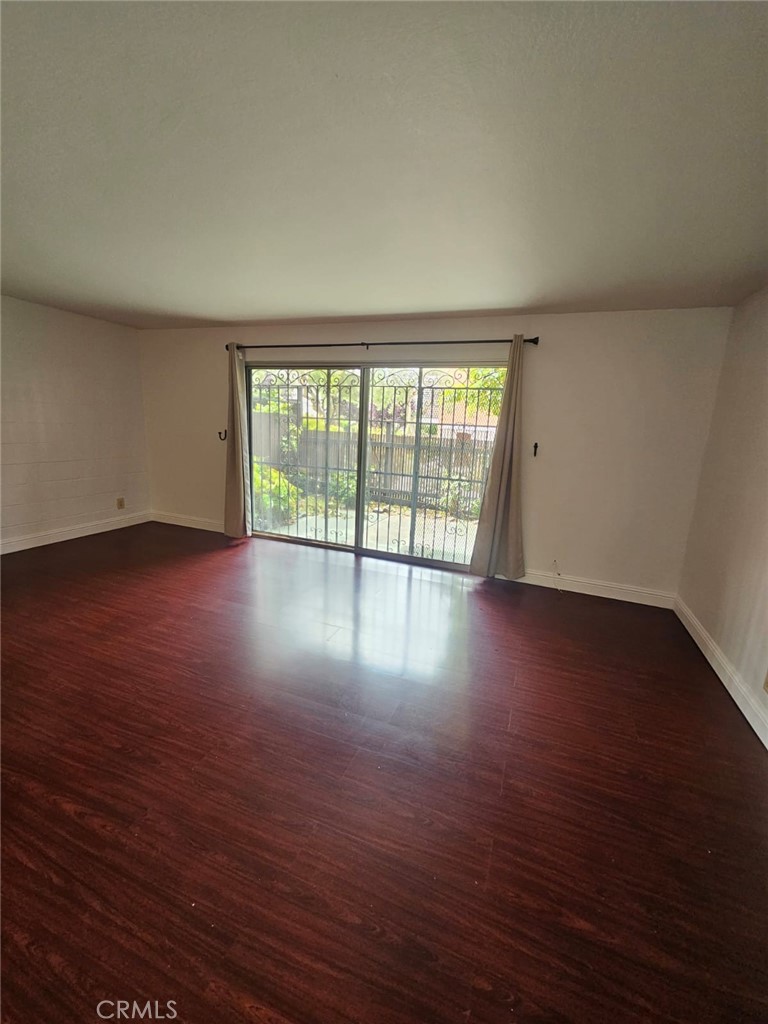 75 Western Shore Lane, Unit 1 San Francisco, CA 94115 - Photo 13 of 17 a view of an empty room with wooden floor and a window