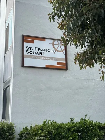 a sign on a wall next to a road