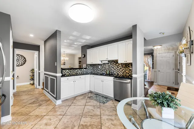 a kitchen with stainless steel appliances kitchen island granite countertop a refrigerator and a stove top oven