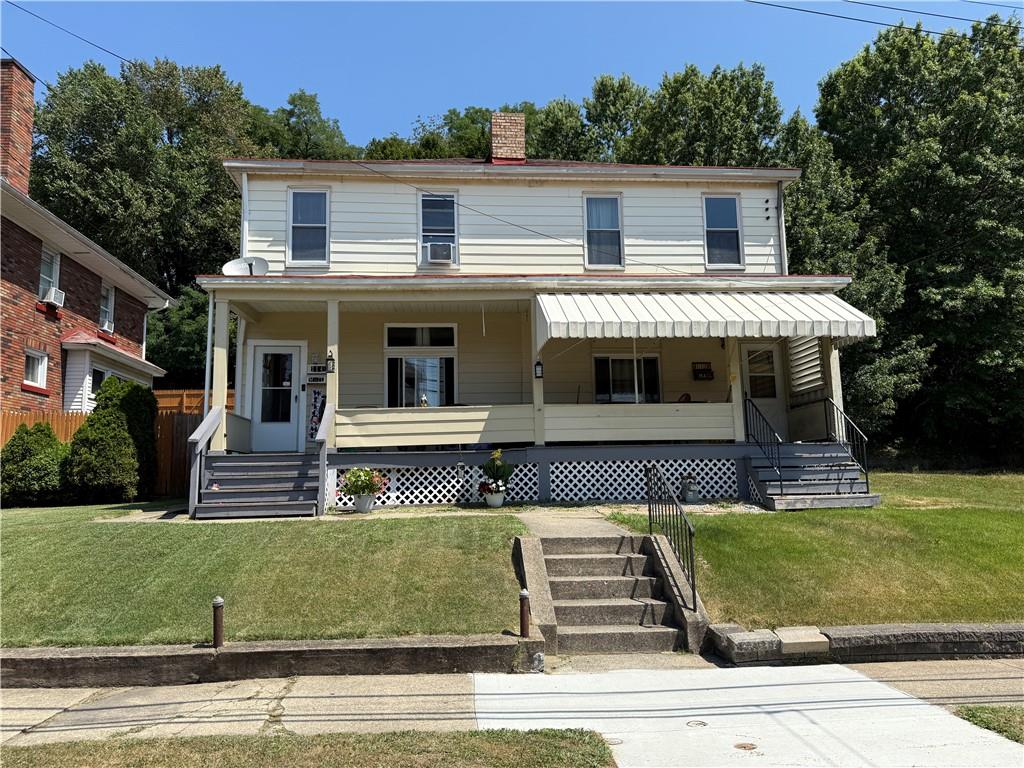 a front view of a house with a garden