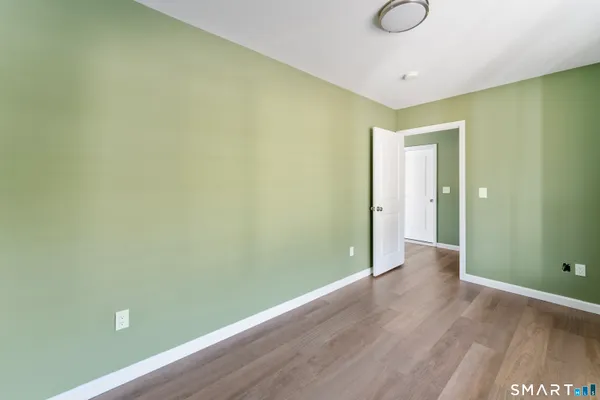 a view of a room with wooden floor and fan