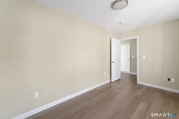 a living room with furniture a window and a potted plant