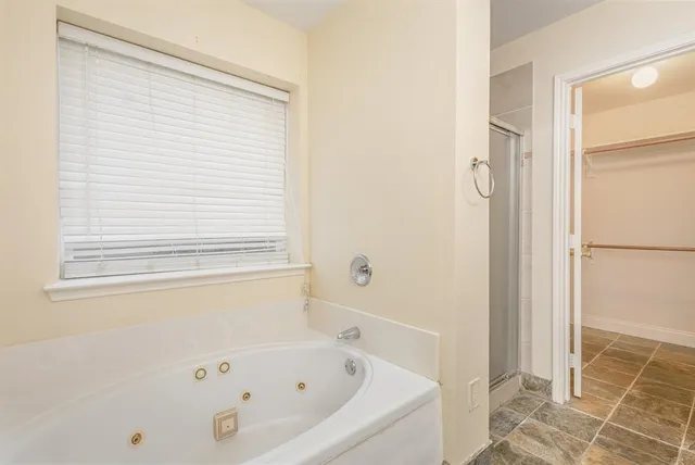 a bathroom with a bathtub and a shower