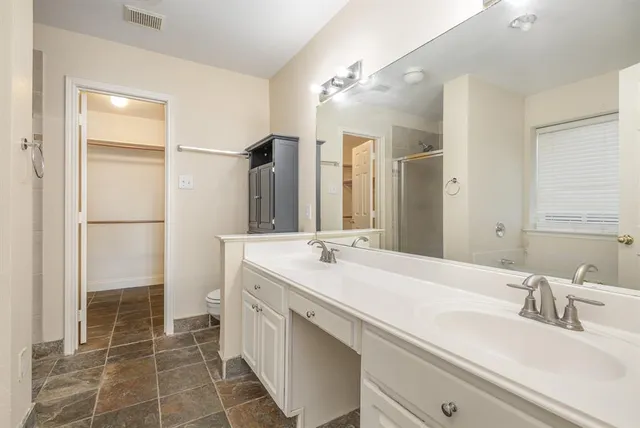 a bathroom with a sink double vanity and a shower