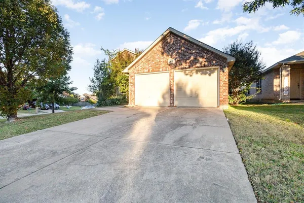a view of a house with a yard and garage