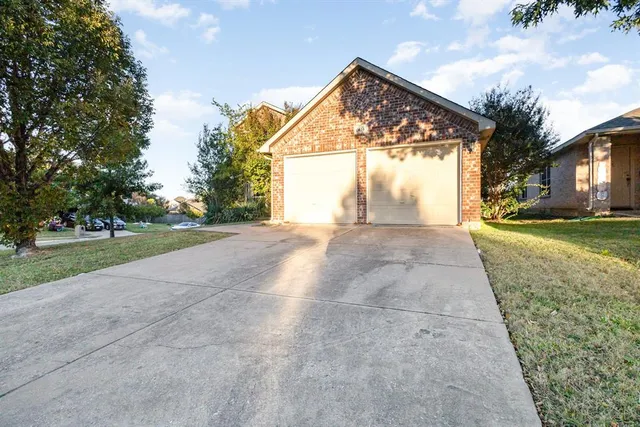 a view of a house with a yard and garage