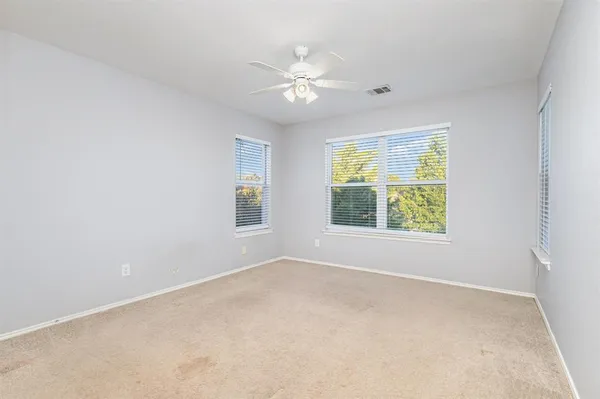 a view of a livingroom with a ceiling fan and window