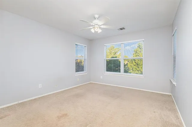 a view of a livingroom with a ceiling fan and window