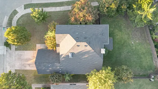 an aerial view of a house with a yard