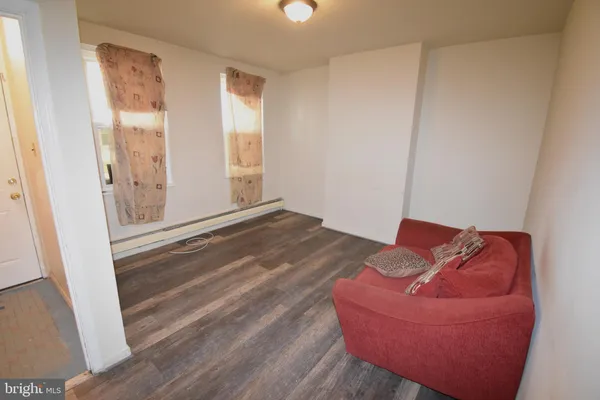 a view of a room with wooden floor and couch