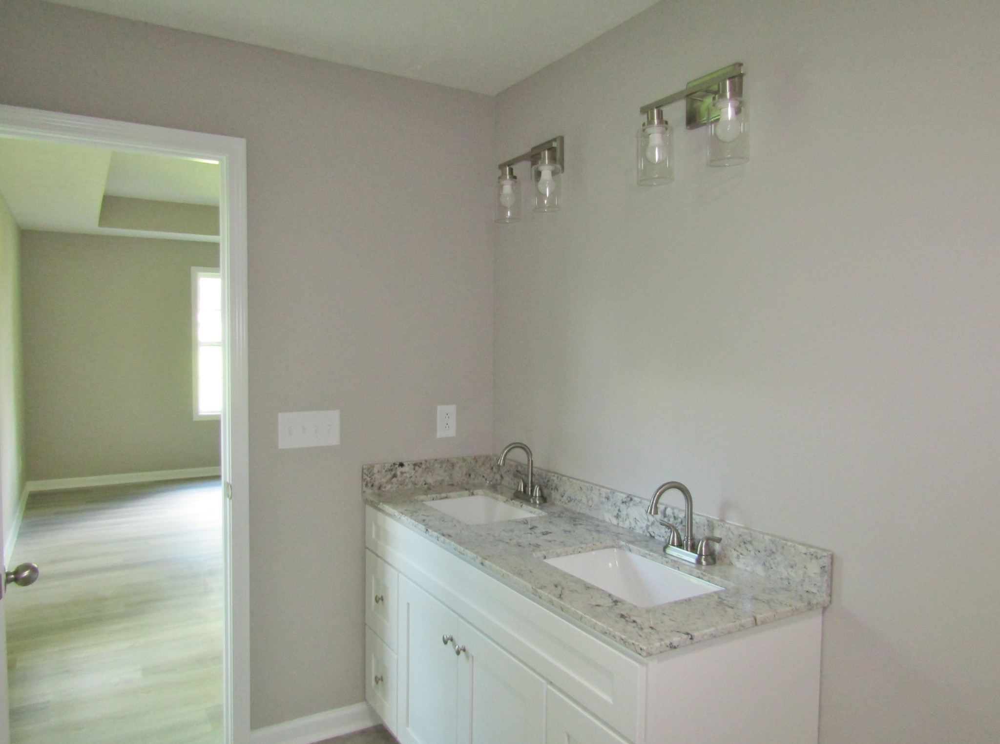 306 Ostella Road Cornersville, TN 37047 - Photo 11 of 15 a bathroom with a granite countertop sink and a mirror
