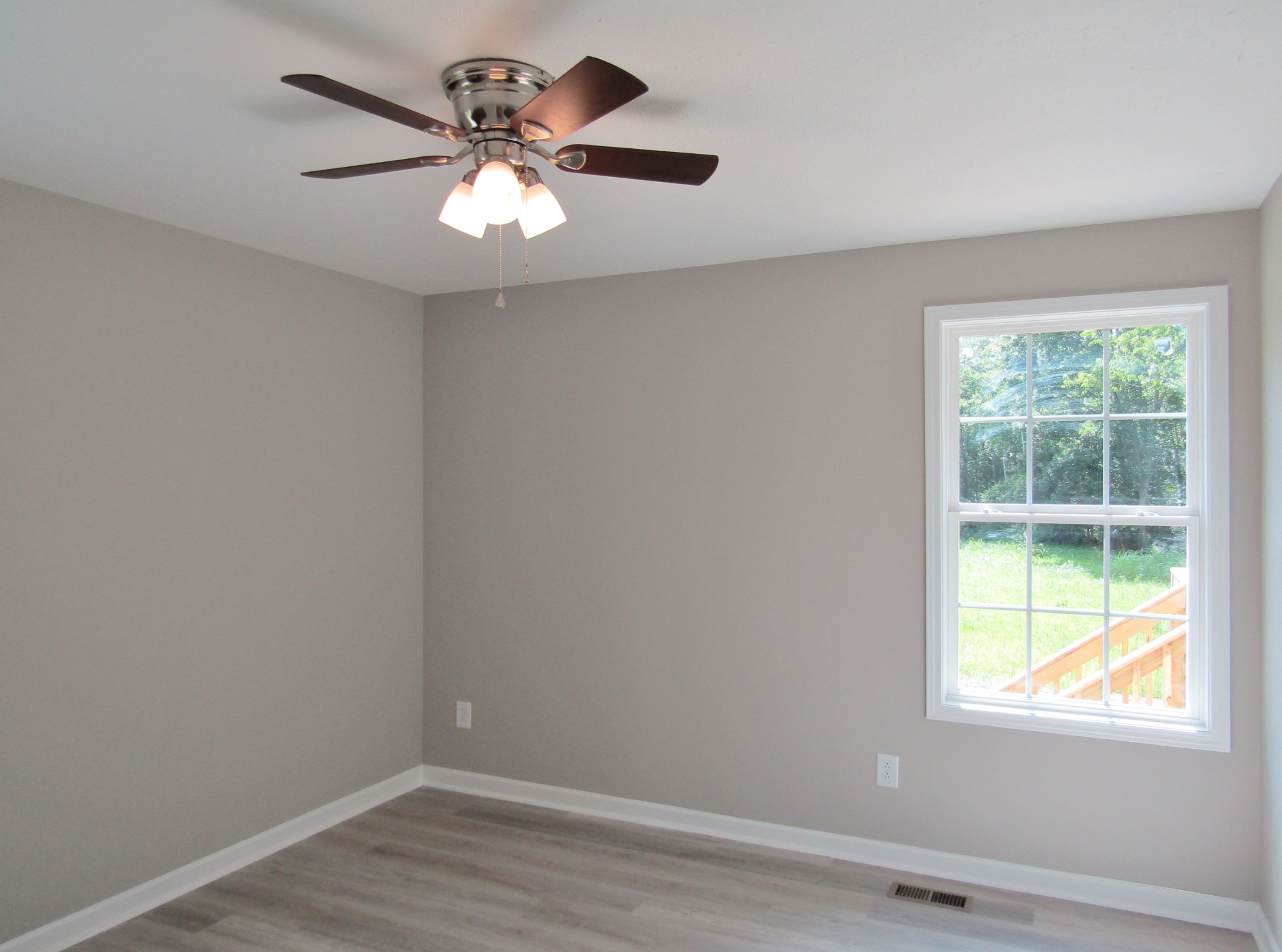 306 Ostella Road Cornersville, TN 37047 - Photo 14 of 15 an empty room with wooden floor and windows