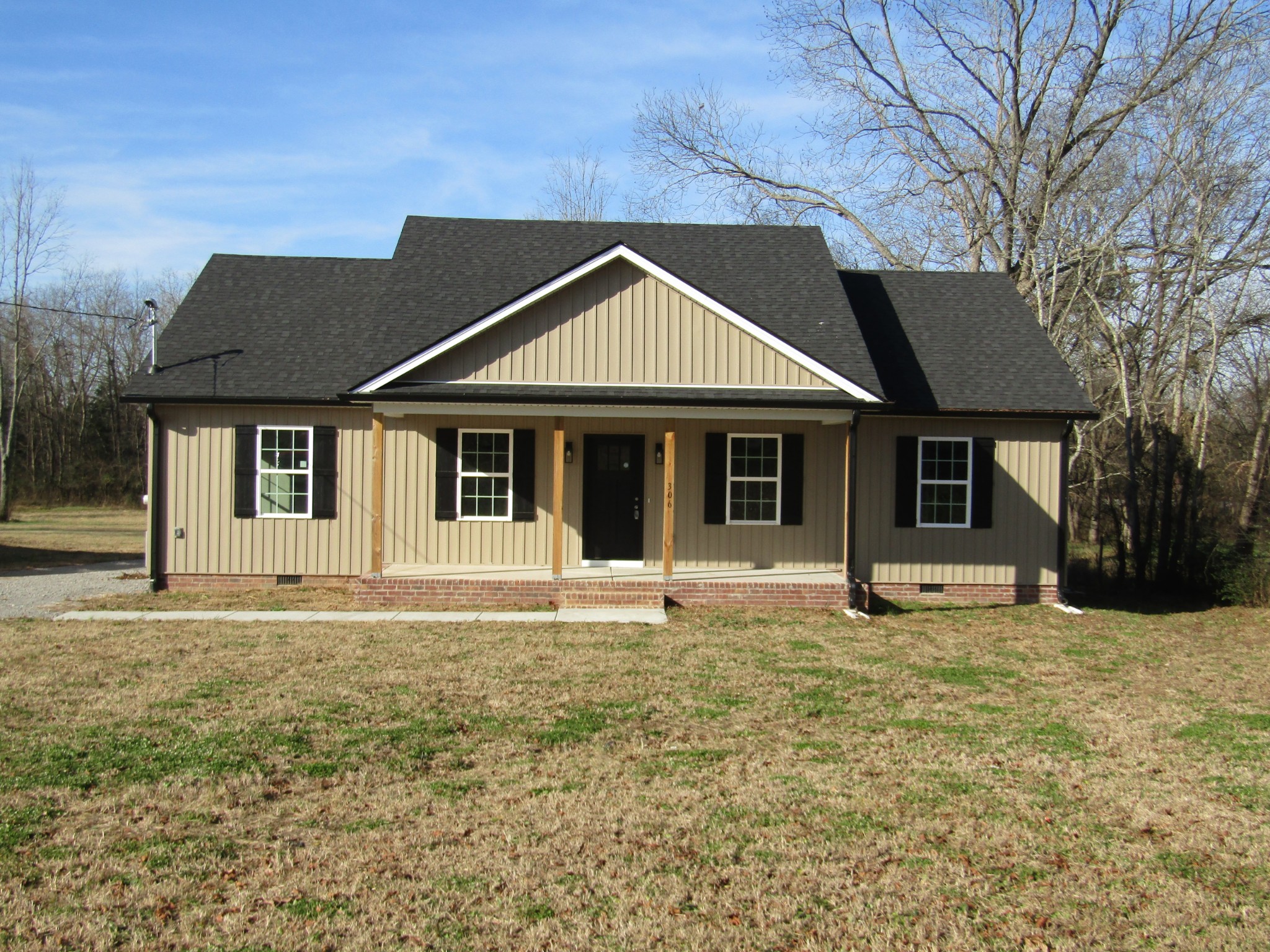 306 Ostella Road Cornersville, TN 37047 - Photo 2 of 15 a front view of a house with a garden