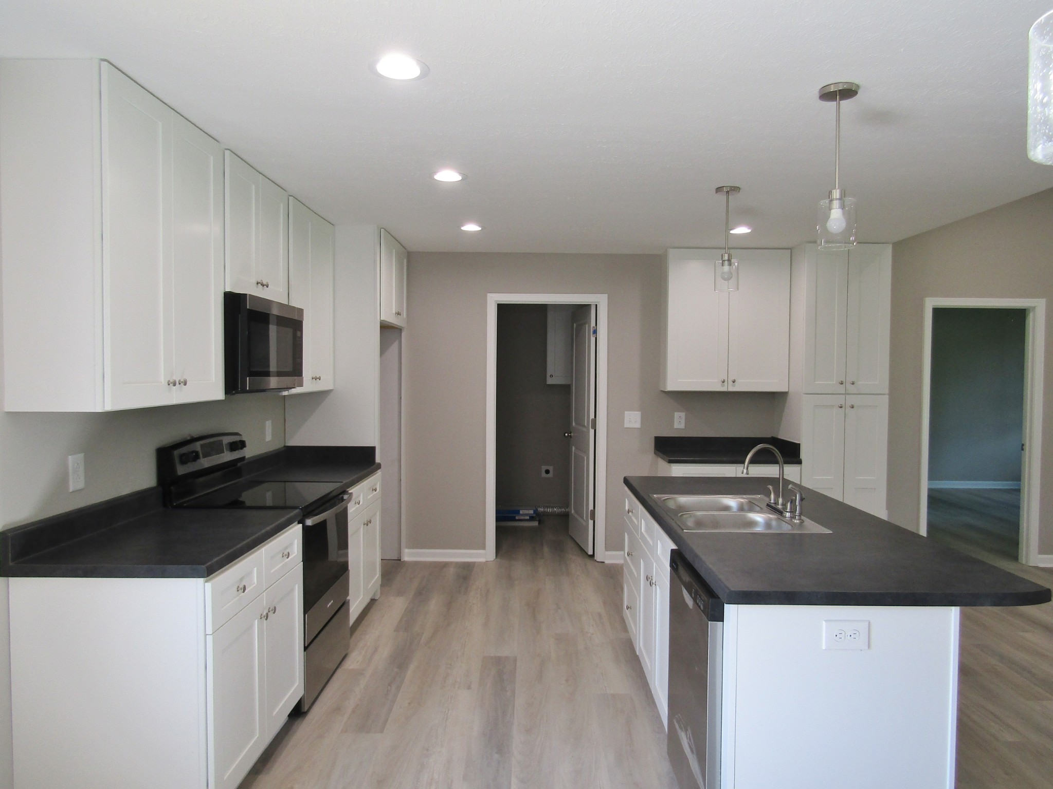 306 Ostella Road Cornersville, TN 37047 - Photo 6 of 15 a kitchen with granite countertop stainless steel appliances a stove a sink a refrigerator and a stove
