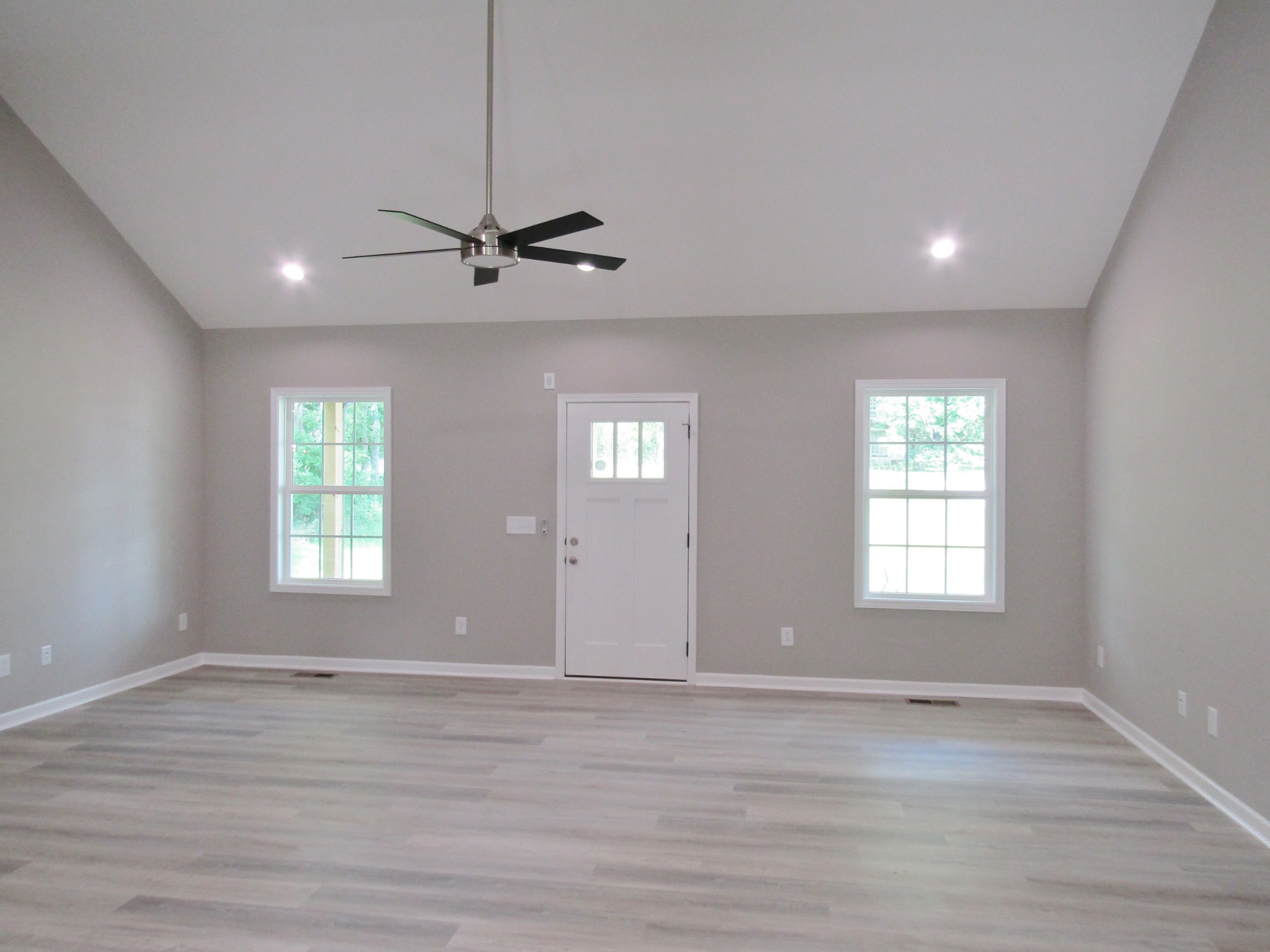 306 Ostella Road Cornersville, TN 37047 - Photo 7 of 15 a view of an empty room with wooden floor and a window