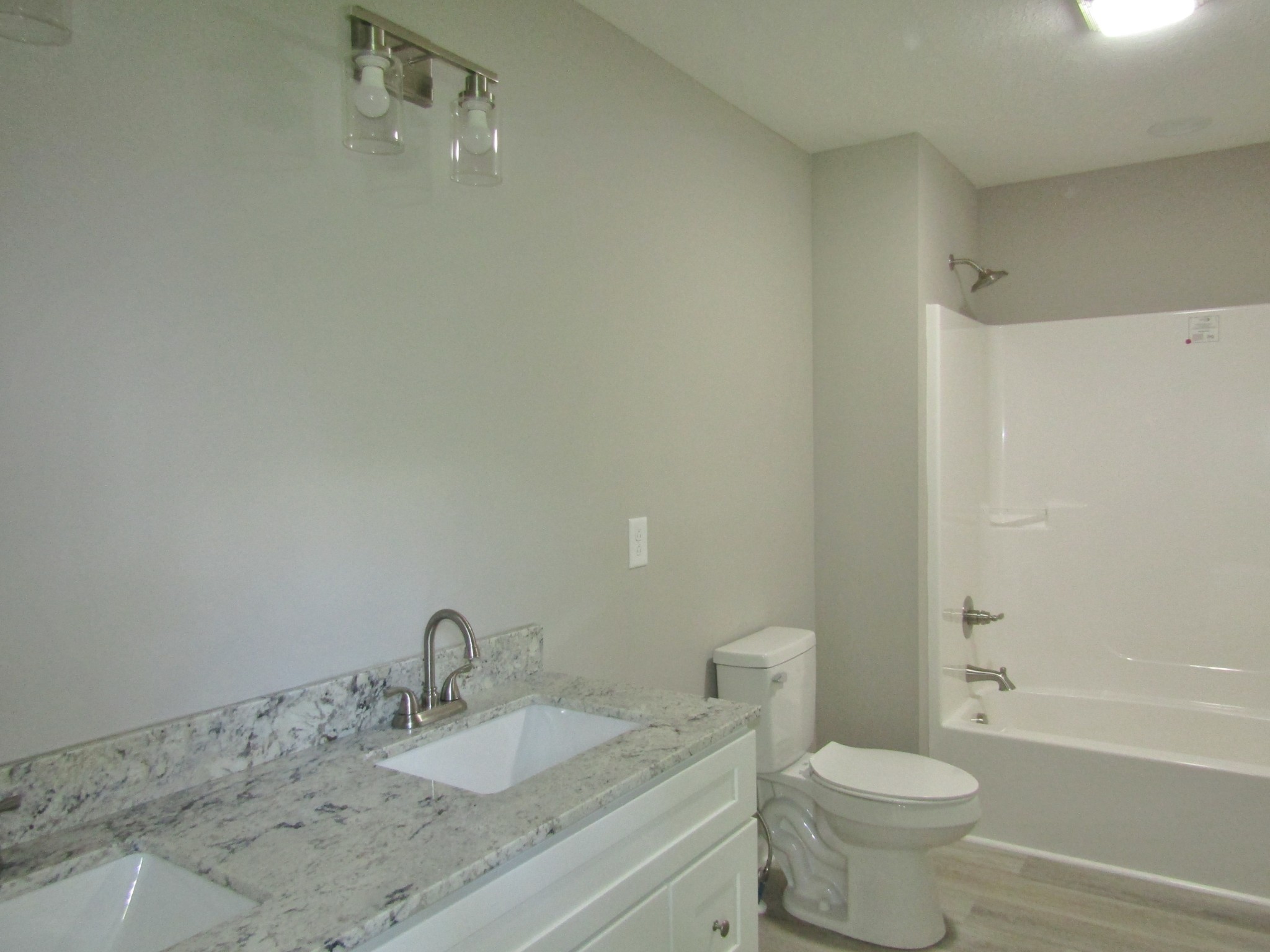 306 Ostella Road Cornersville, TN 37047 - Photo 10 of 15 a bathroom with a granite countertop sink a toilet and shower