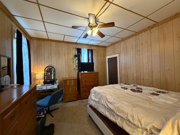 a bedroom with a bed and a chandelier