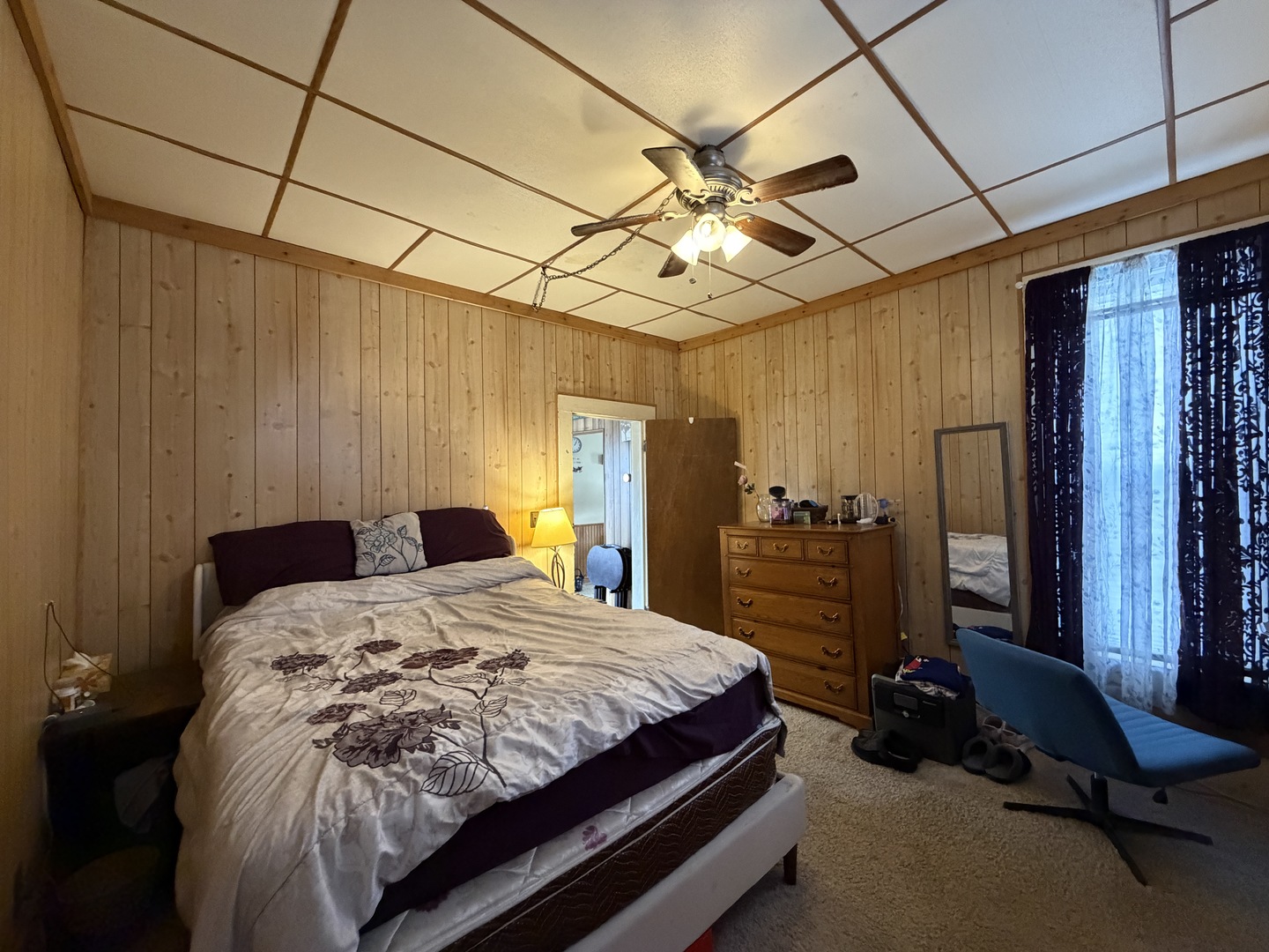 405 East Seminary Avenue Hoopeston, IL 60942 - Photo 18 of 38 a bedroom with a bed and a chandelier