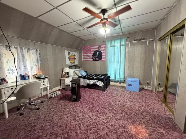 a bedroom with a bed and a table in it