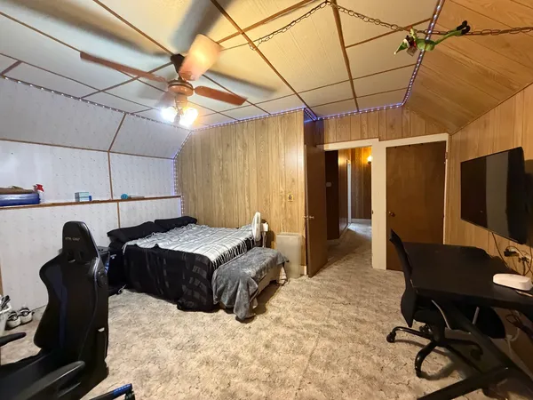a bedroom with furniture and a wooden floor