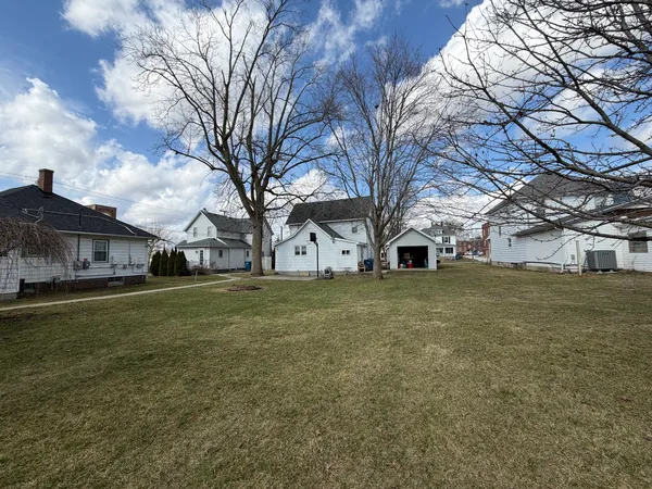 a view of a yard with a large tree