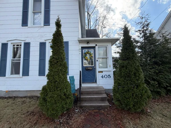 a front view of a house with a garden