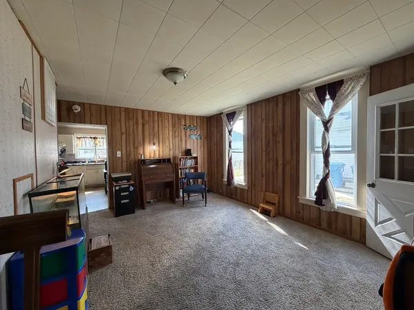 a view of a livingroom with furniture and windows