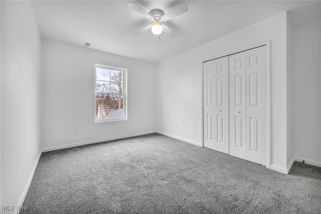 3734 Pennington Road Cleveland, OH 44120 - Photo 34 of 45 Unfurnished bedroom featuring carpet floors, a closet, and a ceiling fan