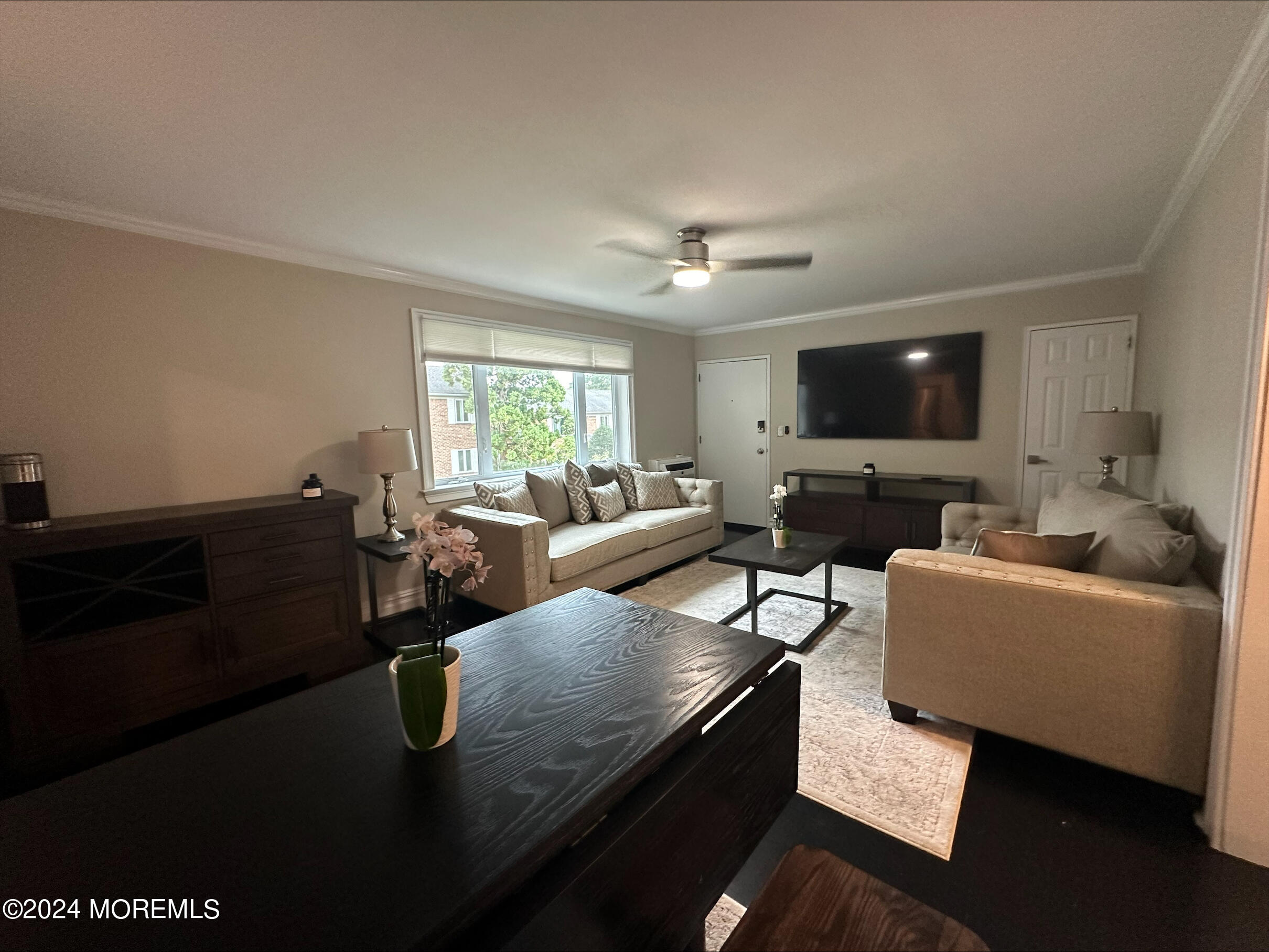 283 Spring Street, Unit 3D Red Bank, NJ 07701 - Photo 1 of 18 a living room with furniture and a flat screen tv