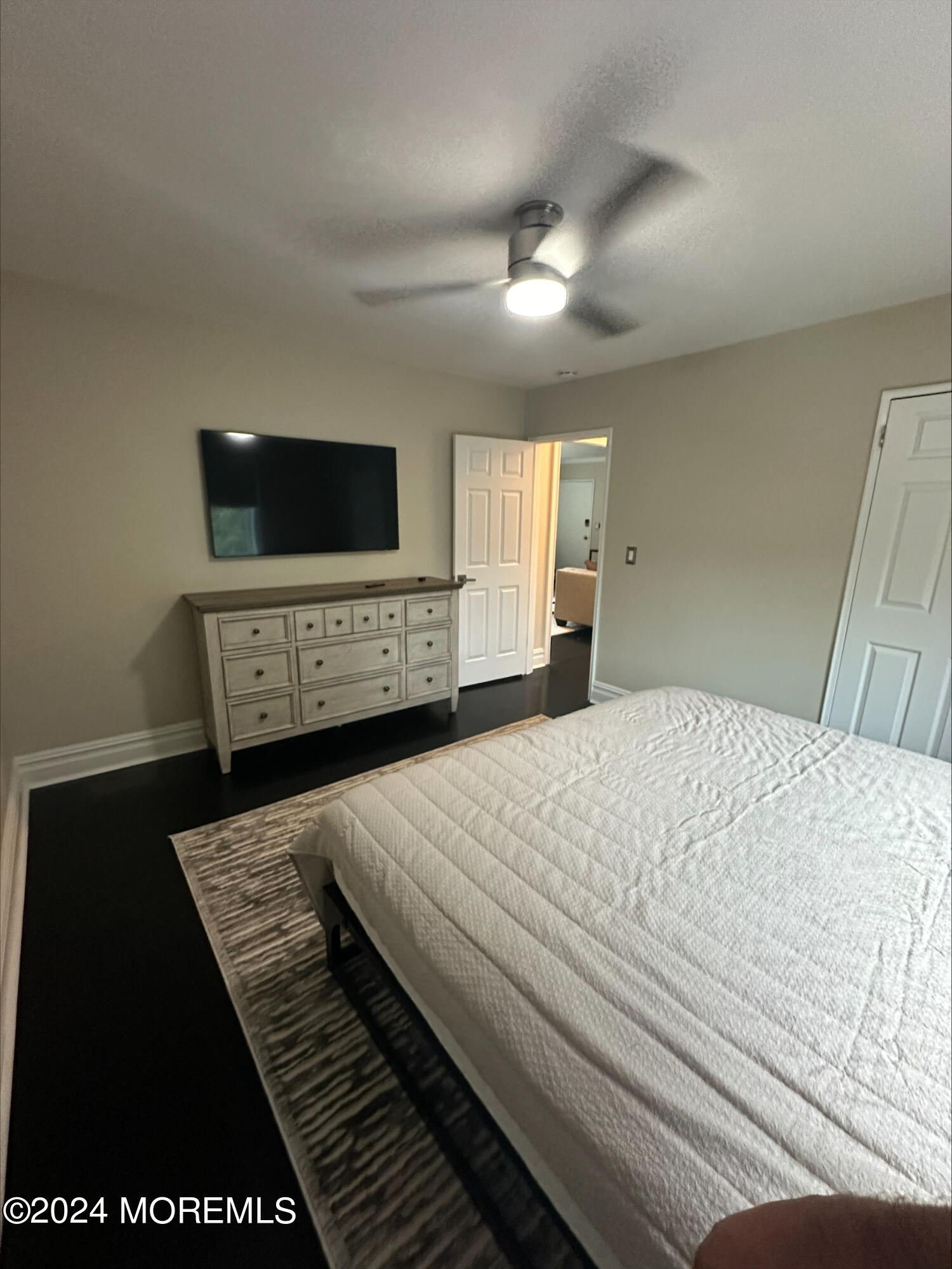 283 Spring Street, Unit 3D Red Bank, NJ 07701 - Photo 14 of 18 a bedroom with a bed and a flat screen tv