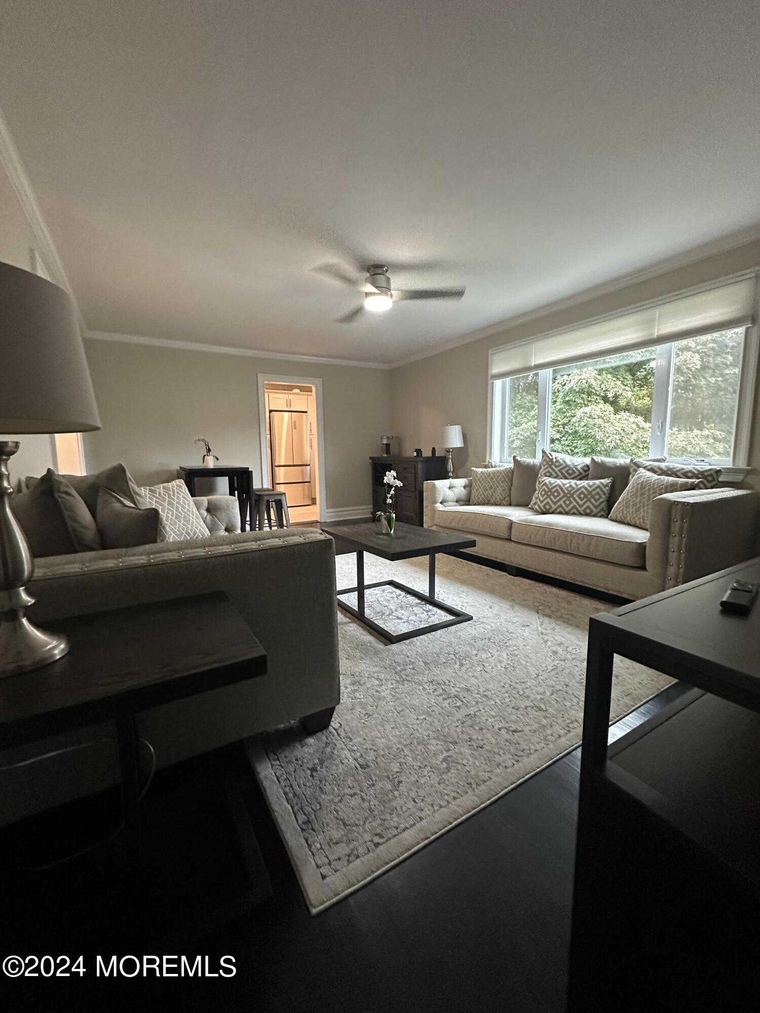 283 Spring Street, Unit 3D Red Bank, NJ 07701 - Photo 2 of 18 a living room with furniture and a large window