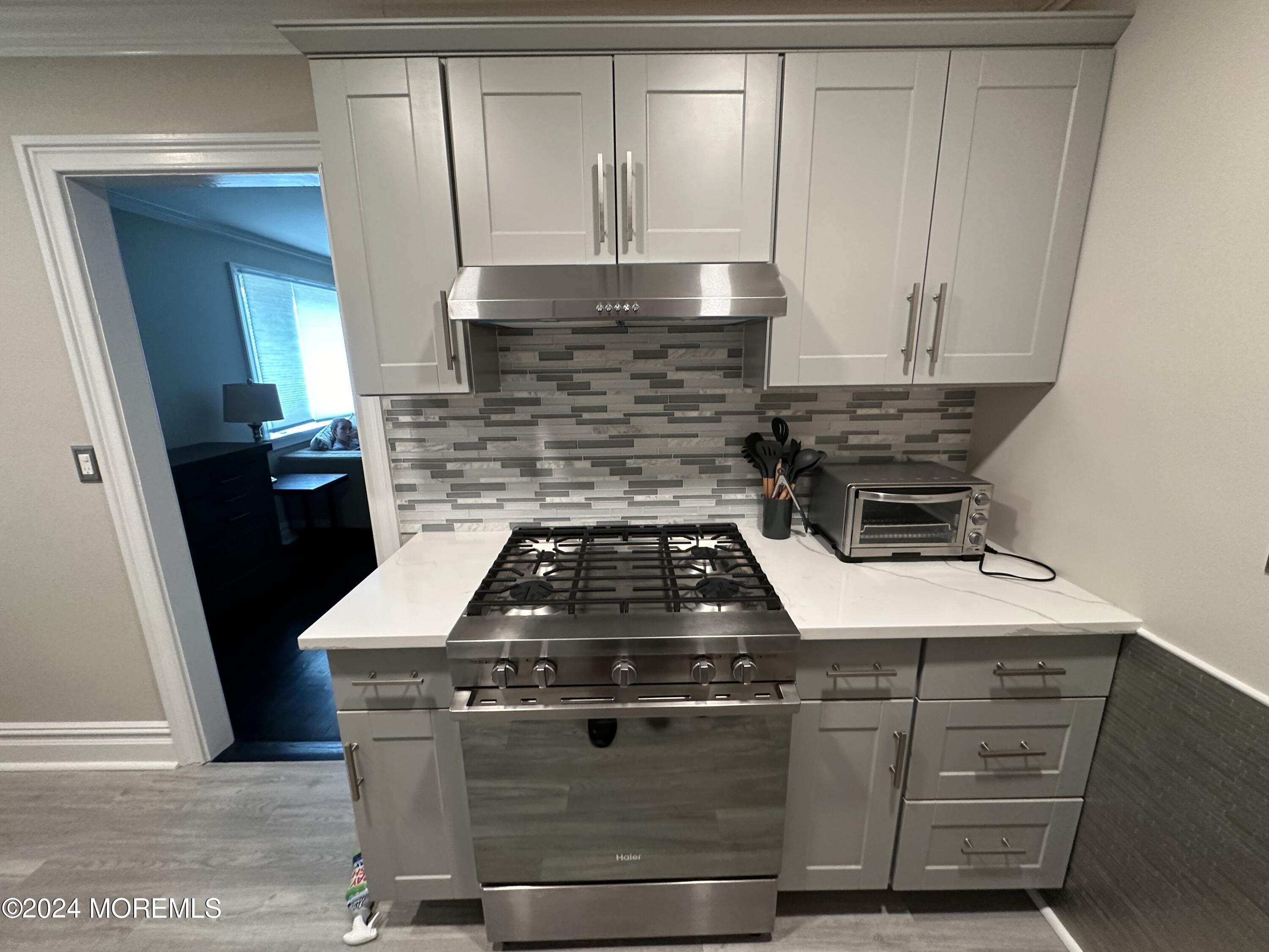 283 Spring Street, Unit 3D Red Bank, NJ 07701 - Photo 4 of 18 a stove top oven sitting inside of a kitchen