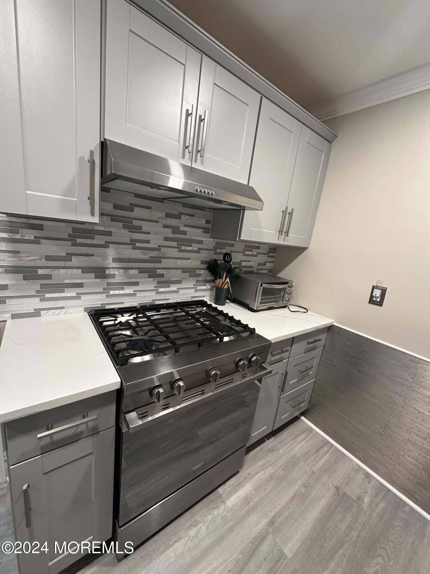 283 Spring Street, Unit 3D Red Bank, NJ 07701 - Photo 6 of 18 a stove top oven sitting inside of a kitchen